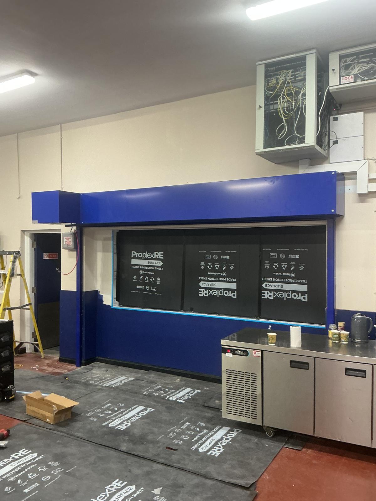 Counter shutter closed across a retail servery