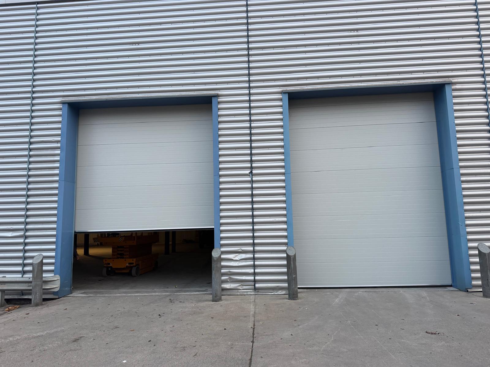 Pair of sectional doors fitted to adjacent bays on a commercial unit